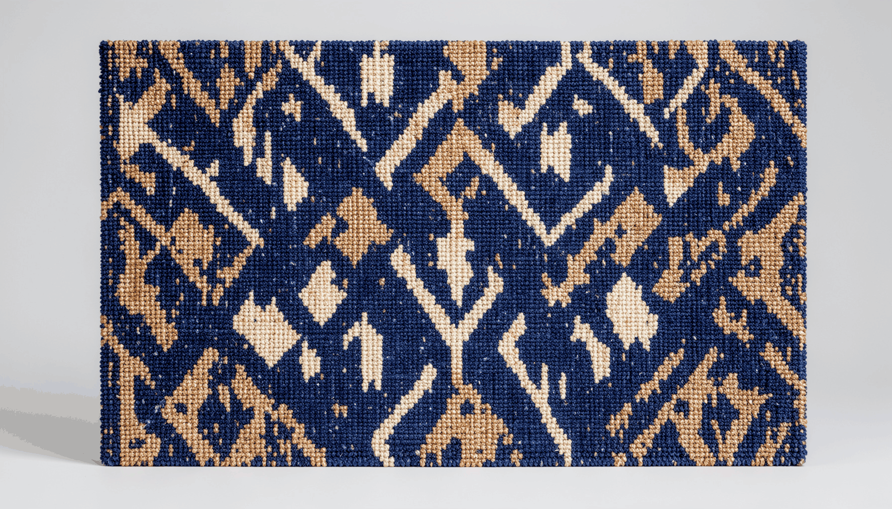 A textured woven textile wall panel in deep navy and warm cream tones with a geometric abstract pattern, calm and dignified mood